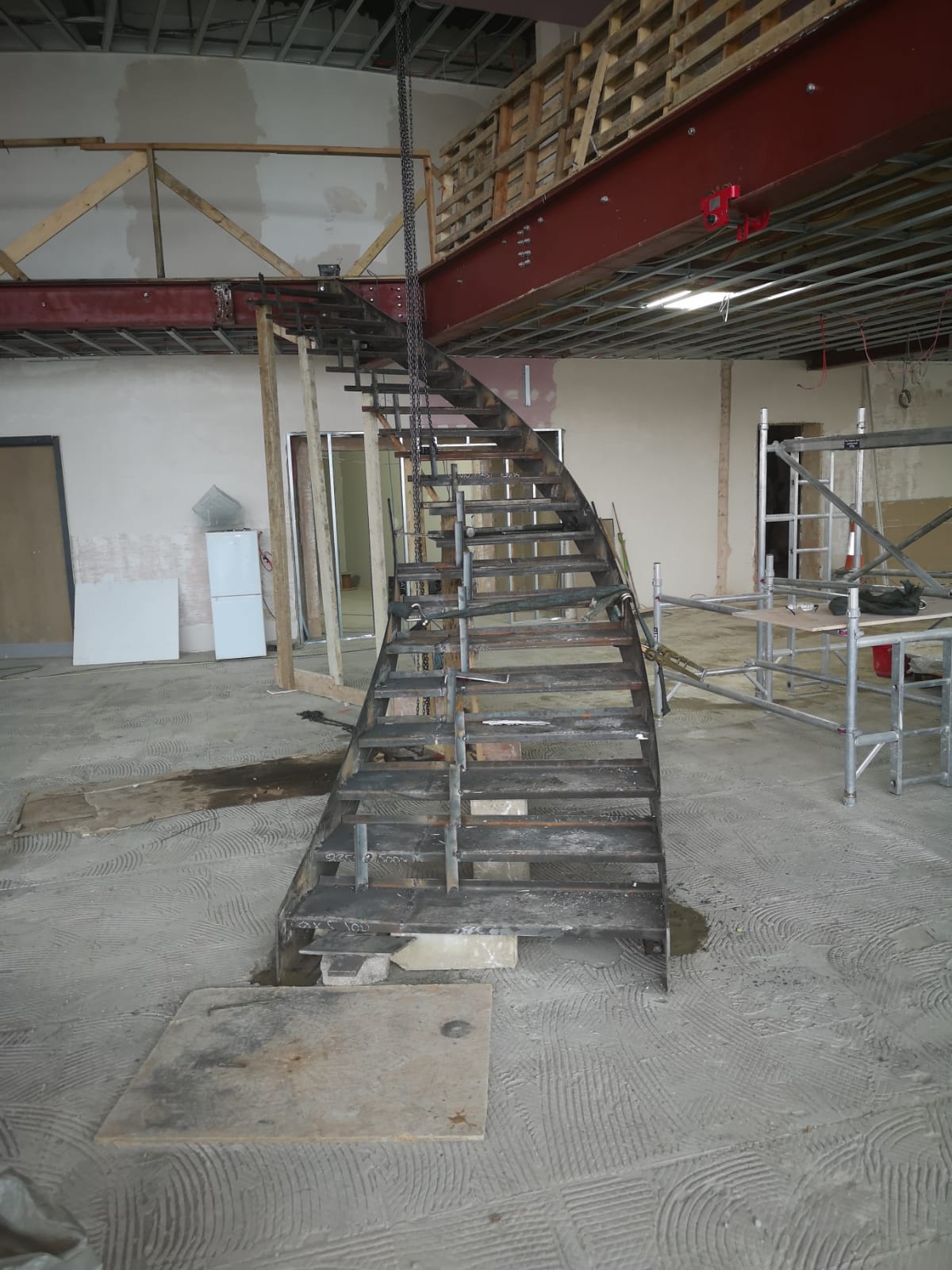 Fabricated steel staircase and mezzanine beam installed in a commercial fit-out